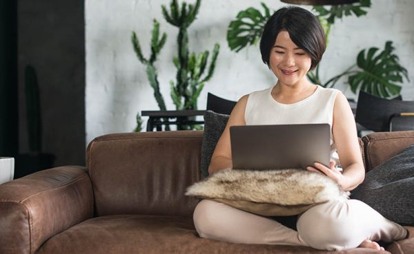 A beautiful Chinese cougar working on her laptop