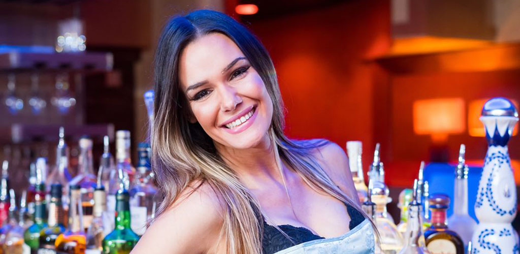 A gorgeous woman posing at the bar in Blue Martini