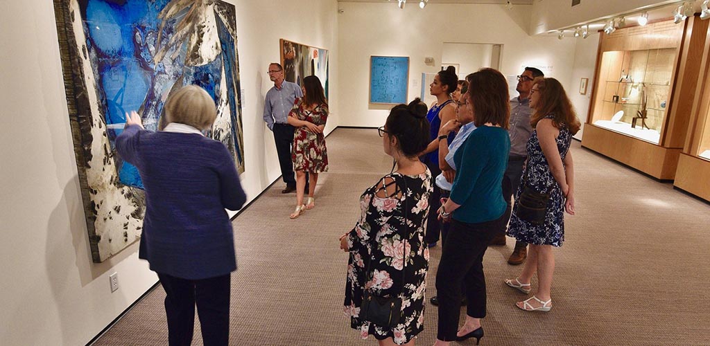 A group of women admiring the artwork at the Boise Art Museum