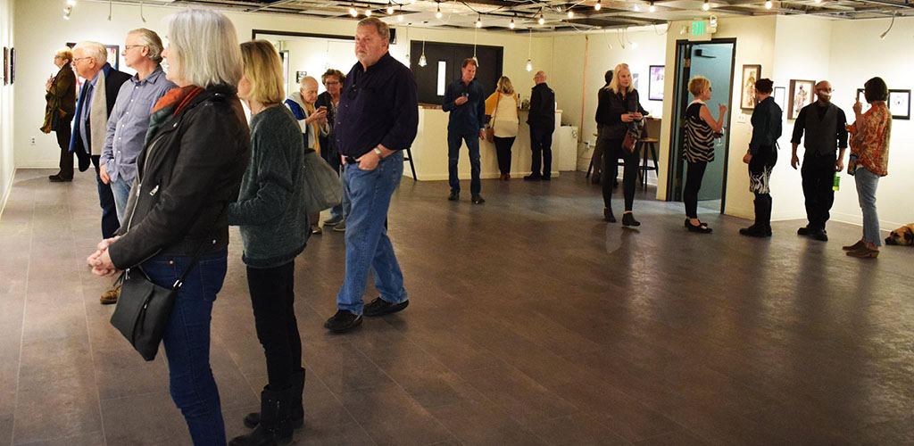 People admiring the artwork at Cottonwood Center for the Arts