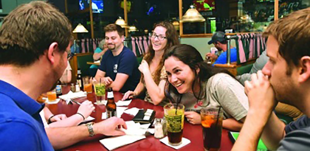 Friends having fun at a Geeks who Drinks event on Tapology Texas Pub