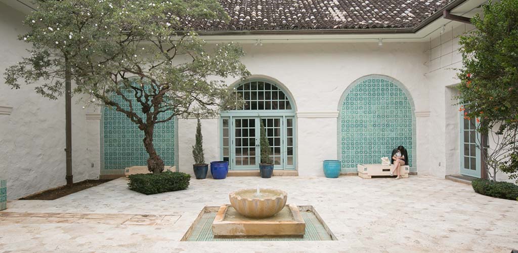 A woman taking a break in the courtyard of the Honolulu Museum before Art After Dark