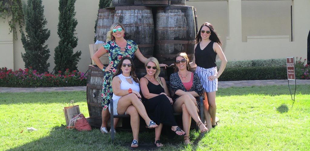 Beautiful mature woman posing in front a large wine barrel at Lakeridge Winery