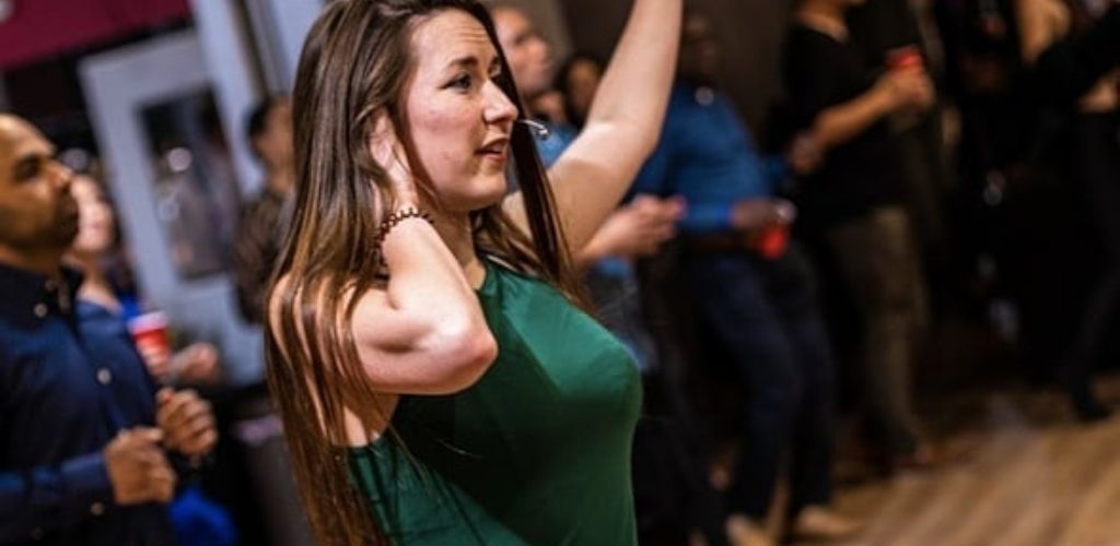 A cute cougar in Washington DC dancing salsa at Salsa with Silvia Studio