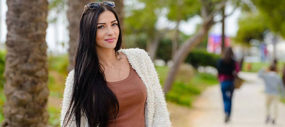Smiling Venezuelan cougar in brown shirt