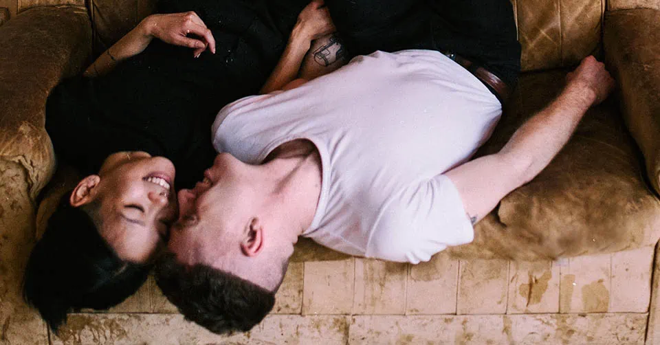 A couple hanging out on a couch