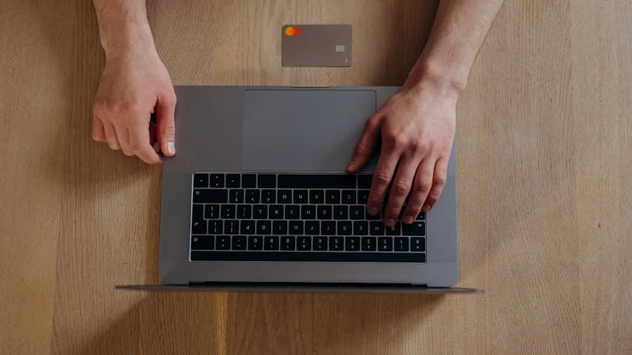 Credit card beside a laptop representing membership costs and upgrades