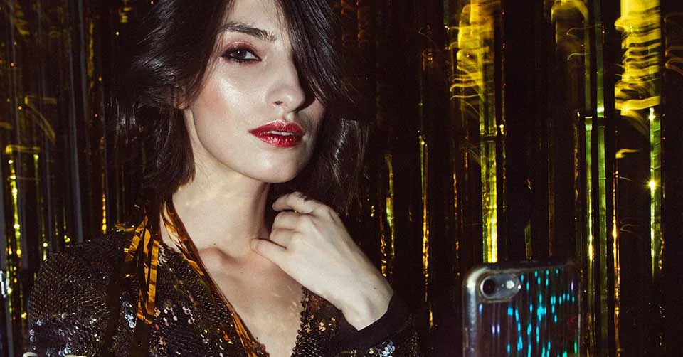 Woman at a party using a dating app